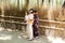 Asian girls in kimono yukata are taking pictures and selfie in Arashiyama Bamboo Grove, Kyoto, Japan