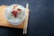 Asian glass fungoza rice noodles and bamboo sticks on a wooden board in a white round bowl with sesame seeds on a black