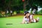 Asian golfer laying on the green grass