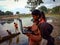 asian government school kids learning about laptop computer system at river bank in india January 2020