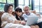 Asian grandparent with little young cute grandchild sitting on sofa playing laptop together. Little granddaughter teach senior eld