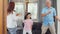 Asian grandparents and granddaughter listen to music and dance together at home. Senior Chinese, grandpa and grandma happy spend