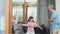 Asian grandparents and granddaughter listen to music and dance together at home. Senior Chinese, grandpa and grandma happy spend