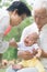 Asian grandparents playing with grandchild