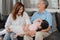 Asian grandparents talking with granddaughter at home. Senior Chinese, old generation, grandfather and grandmother using family