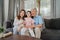 Asian grandparents watch TV with granddaughter at home. Senior Chinese, grandfather and grandmother happy using family time relax