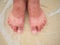 Asian guy foot stand on the beach with ocean crashing to his foo