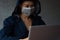 Asian hacker woman with surgical facemask typing on laptop notebook