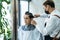 Asian hairdresser barber wear mask, cut hair of attractive man in shop. Handsome young man customer in modern salon barbershop,