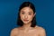 Asian half-naked woman posing and looking at camera