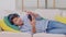 Asian handsome man lying on couch wearing headphone listen music and using mobile or smart phone for choosing music apps or video