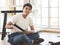 Asian  handsome young  man trying to assemble knock down furniture , smiling and looking at camera