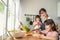 Asian happy family, mother spend time with young daughter in kitchen. Loving beautiful parent mom and little sibling cute girl