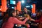 Asian happy group of friends raising glass of cocktails for toast at nightclub