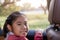 Asian Happy student smiling with camera while enjoying road trip in car. Daughter smiling and looking camera inside car in morning