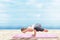 Asian healthy woman practicing yoga on the carpet at sandy beach