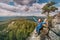 Asian hiker woman enjoys climbing on high mountain in national Park. Beautiful view of the valley