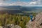 Asian hiker woman enjoys climbing on high mountain in national Park. Beautiful view of the valley