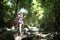 Asian hipster tourism women take a photo of waterfall in deep forest.