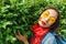 Asian hipster woman with yellow fashionable glasses posing in park