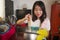 Asian home cook girl lifestyle portrait . Young happy and beautiful Korean woman in kitchen apron and glove holding cooking pot