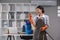 An Asian housewife uses a telephone to communicate with her employer. During cleaning in the office