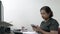 Asian Indian businesswoman messaging on her cellphone at her office desk.