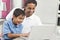 Asian Indian Father & Son Using Laptop Computer