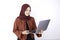 Asian Islam woman is standing and smiling face with hand holding laptop