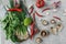 Asian or italian food preparation. Mushrooms, green onion, red pepper, lime, garlic and herbs on light concrete background, healt