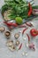 Asian or italian food preparation. Mushrooms, green onion, red pepper, lime, garlic and herbs on light concrete background, healt