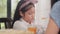 Asian Japanese daughter bored with food. Lifestyle kids sad dislike food upset breakfast meal in the kitchen at home in the