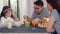 Asian Japanese family has breakfast at home. Asian mom, dad, and daughter feeling happy talking together while eat bread, corn