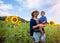 Asian kid or baby boy and happy young mother in sunflower meadow