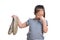 Asian kid girl age 7 year hold stinky shoe on white background