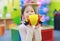 Asian kid girl having fun with Toys, musical instruments