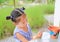 Asian kid girl paint on earthenware dish