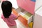 Asian kid open colorful drawer