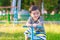 Asian kid riding seesaw board at the playground