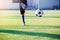 The Asian kid soccer player shoot bounce ball on artificial turf to goal