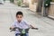 Asian kid students exercise bicycle outdoor in front of the village for lifestyle fun happy ride biking training enjoying Learn to