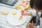 Asian Kids decorating cookies.