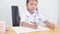 Asian kids - Thai girl in student uniform writing notebook