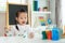 Asian kindergarten school girl looking happy and smile while painting Plaster doll with Acrylic water color paint in living room