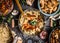 Asian kitchen table with food bowls, wok , stir fry , chopsticks and ingredients on background