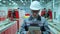 Asian, Korean professional engineer man in hard hat using tablet indoors