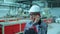 Asian Korean professional male engineer in hard hat using mobile phone smartphone