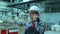 Asian Korean professional male engineer in hard hat using mobile phone smartphone