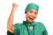 Asian Korean woman as excited physician - young beautiful and happy medicine doctor or chief hospital nurse in green scrubs and