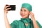 Asian Korean woman as successful taking selfie on hand phone - young beautiful and happy medicine doctor or hospital nurse taking